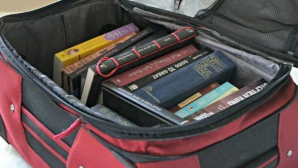 Neatly packed suitcase with dorm essentials for college students.