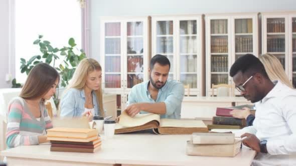 Students preparing for college with notebooks, laptop, and planner on a study desk.